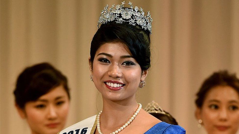 Priyanka Yoshikawa smiles as she holds the trophy after winning the Miss Japan title during the Miss World Japan 2016