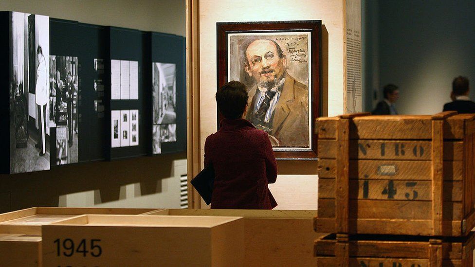A visitor looks at a painting at the 'Looting and Restitution' ('Raub und Restitution') exhibition at the Jewish Museum on September 18, 2008 in Berlin, Germany. The exhibition detailed the looting of Jewish art collections and household objects by the Nazi regime before and during the Second World War. and the various institutions put in place to find and return the looted goods.