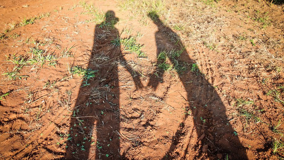 A man and a woman's shadow on the ground