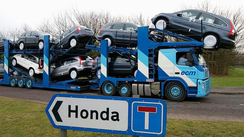 A transporter loaded with Honda cars leaves the Honda car factory in Swindon