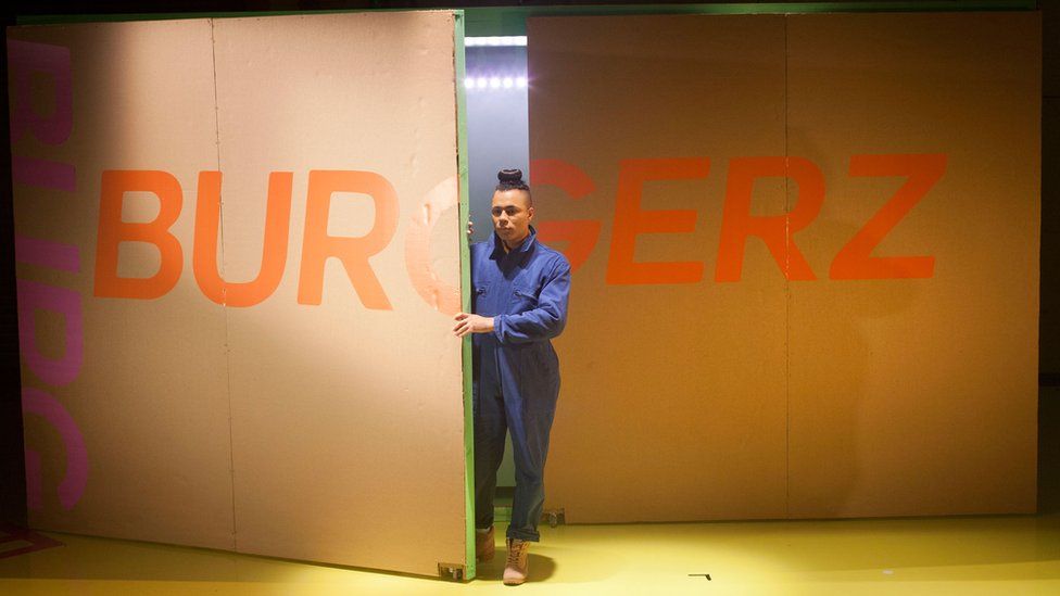 Travis in their production of Burgerz