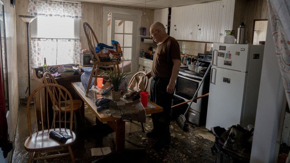 Gordon George, of Barre, Vermont, worked with his daughter, Danielle Palmer, of Washington, to survey the damage to his home