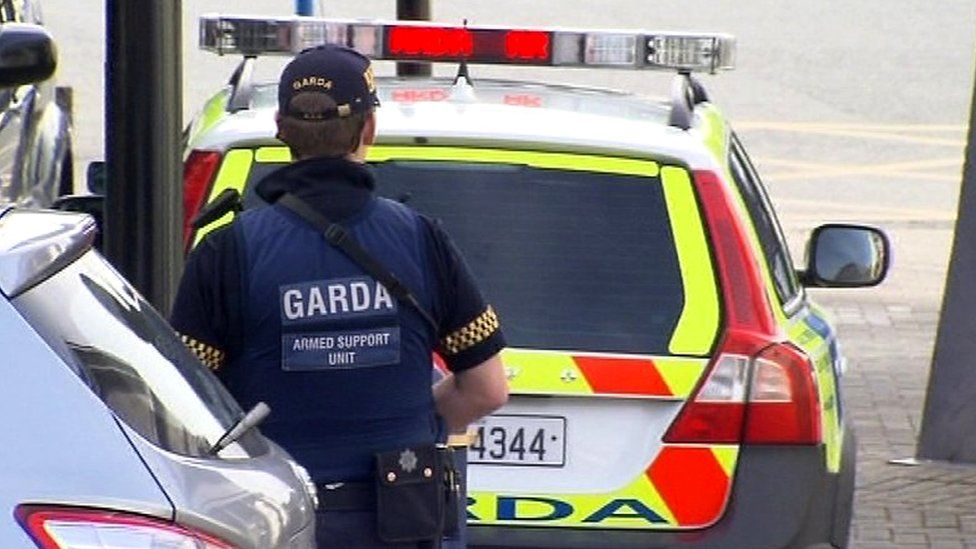 A Garda officer is seen in full uniform and bullet proof vest