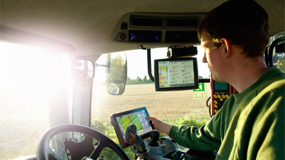 Man driving tractor with GPS