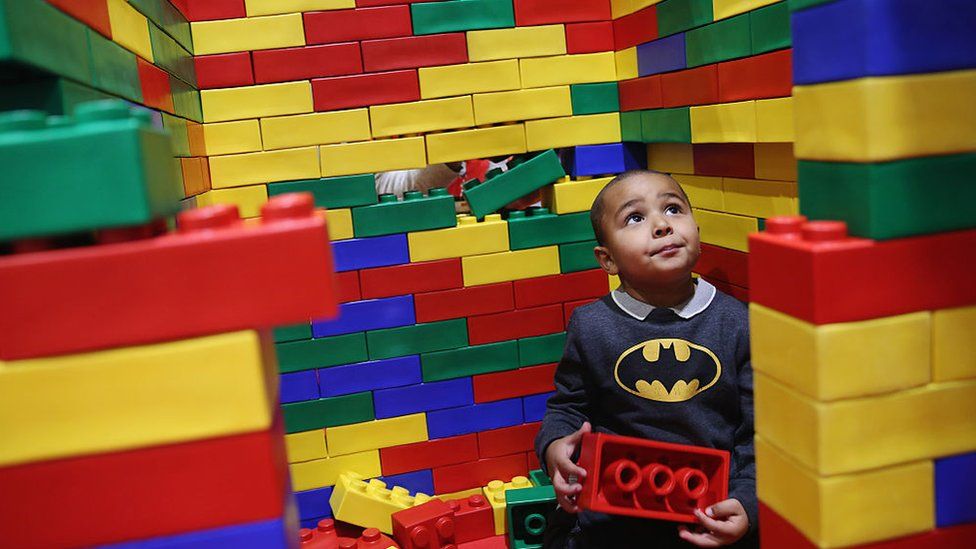 A young boy playing with Lego