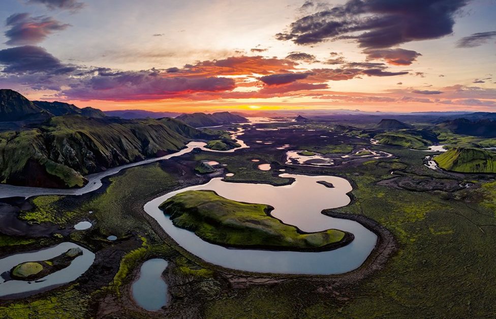 A landscape showing many lakes at sunrise