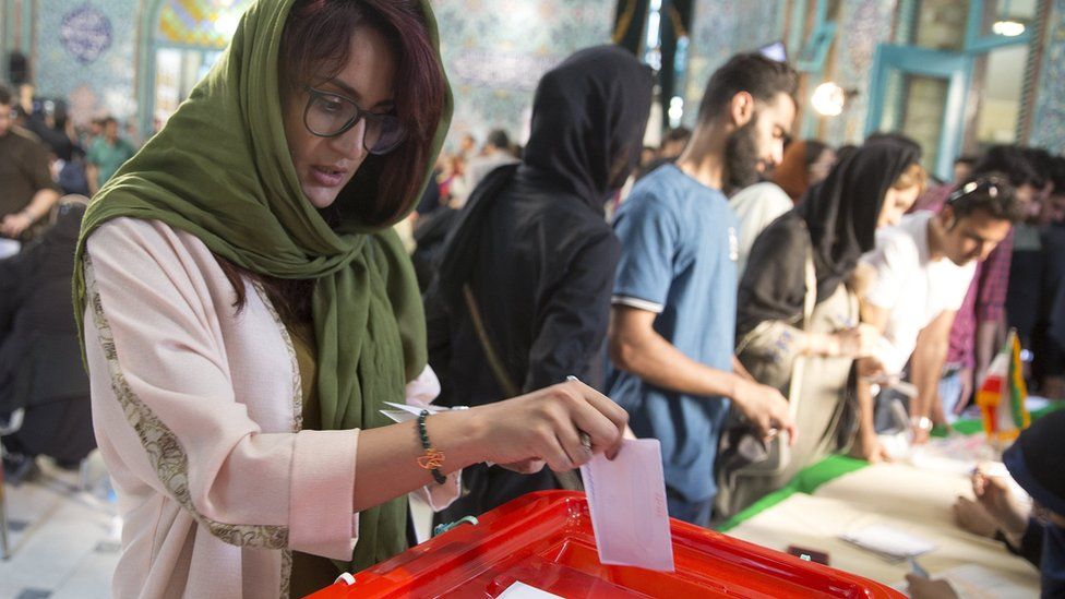 Iranian voters cast their ballots for the presidential and municipal council election