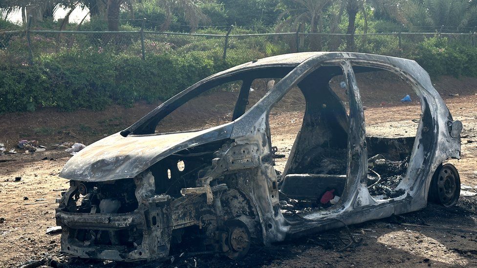 A car is wrecked in clashes between the Sudanese Armed Forces and the paramilitary Rapid Support Forces (RSF) despite the ceasefire in Khartoum