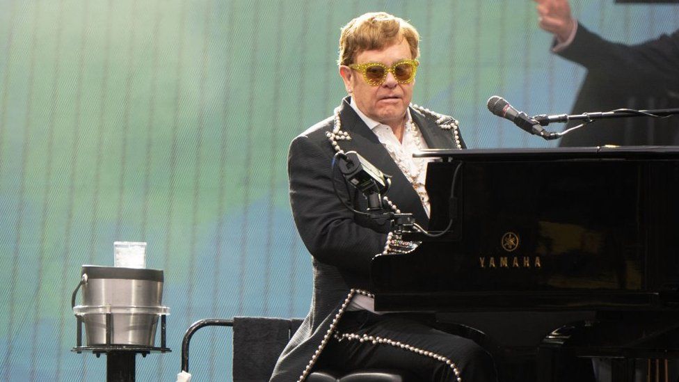 Elton John singing and playing the piano at Norwich gig