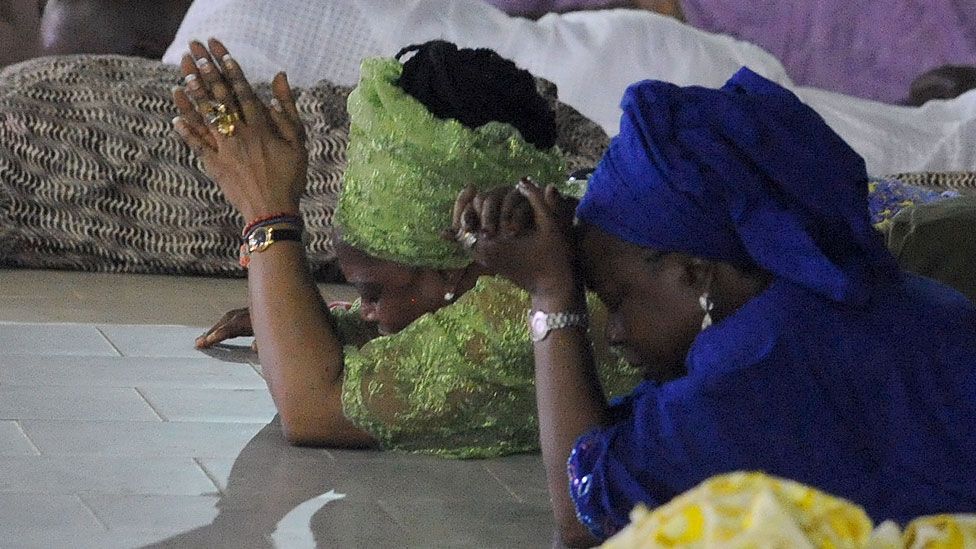 Worshippers pray into the New Year during the crossover watch night church service at the Redemption Camp on Lagos Ibadan highway on Janauary 1, 2014