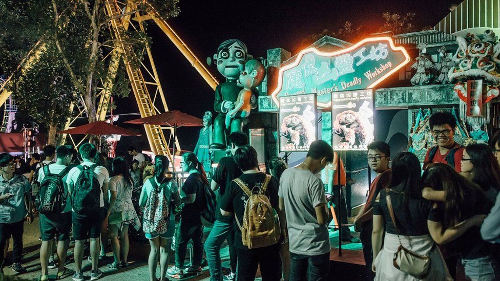People queue for the haunted house at Halloween event at Ocean Park on October 30, 2015 in Hong Kong. Hallowee