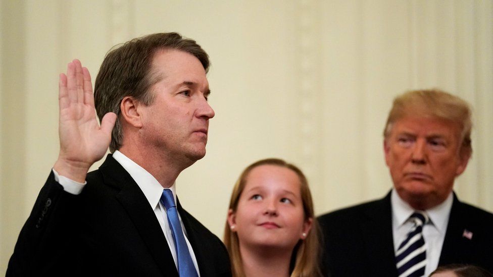 US Supreme Court Associate Justice Brett Kavanaugh is sworn in while his daughters and US President Donald Trump look on, 8 October 2018