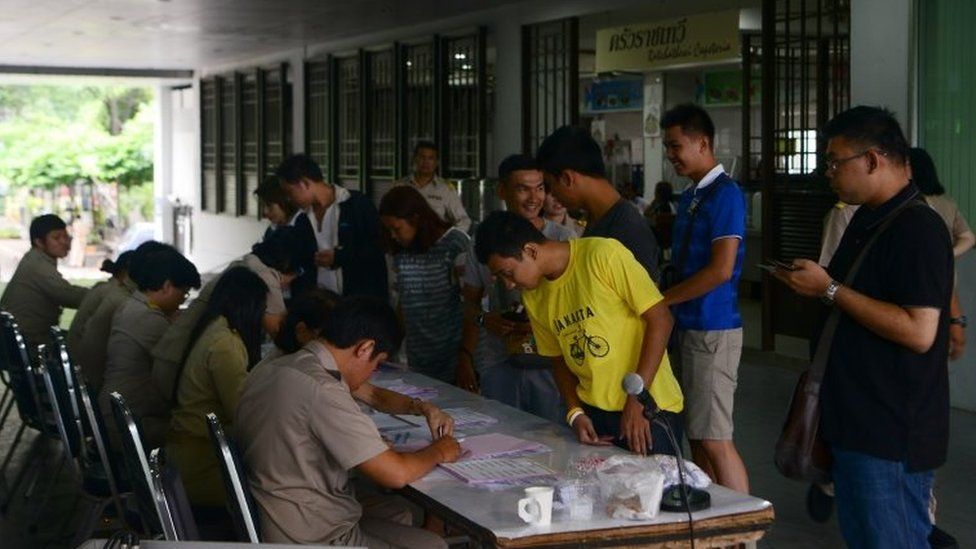 Voters check their names on registration lists as they arrive at a polling station in Bangkok. Photo: 7 August 2016