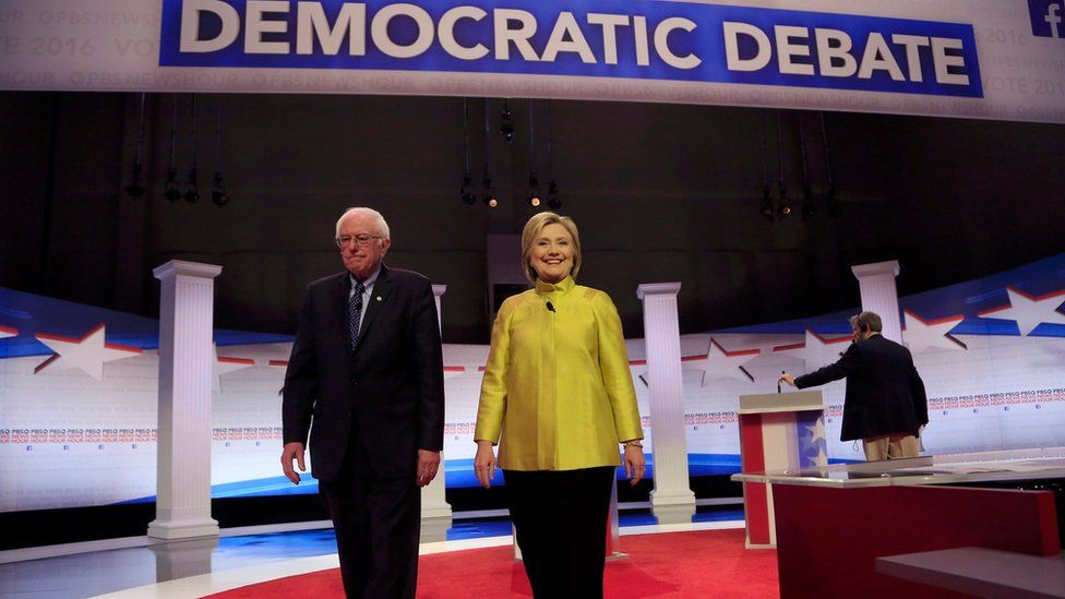 Democratic US presidential candidates Senator Bernie Sanders and former Secretary of State Hillary Clinton arrive on stage