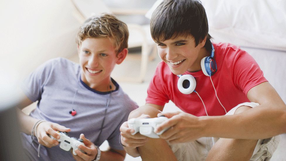 Boys playing video game