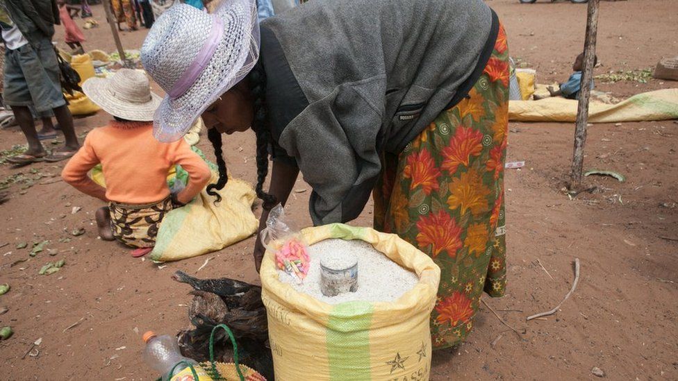 This picture taken in March 2015 shows a street vendor selling rice imported from Pakistan, as a result of the scarcity of non-imported food due to prolonged drought, in the village of Ambonaivo, in the Tsihombe district of southern Madagascar