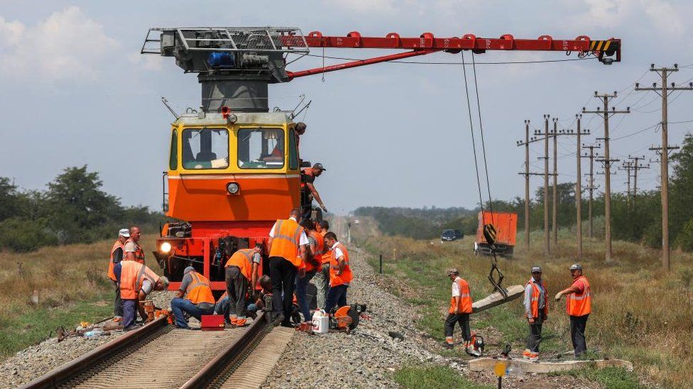 Workers repair a railway near Azovskoye settlement in the Dzhankoi district, Crimea, August 16, 2022