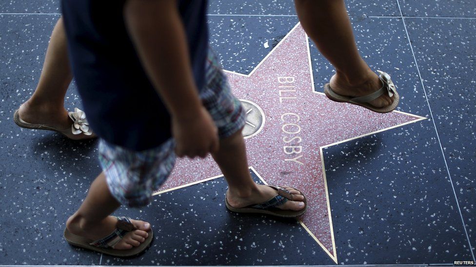 A woman strides over Bill Cosby"s star of the Hollywood Walk of Fame in Los Angeles, California, United States July 9, 2015