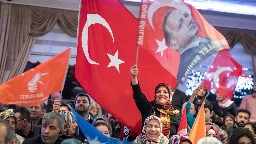 Supporters of Turkish President Recep Tayyip Erdogan wave flags at an AKP election meeting Kelsterbach near Frankfurt am Main