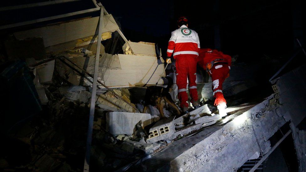 Socorristas buscan sobrevivientes en un edificio colapsado en Sarpol-e Zahab, Irán.
