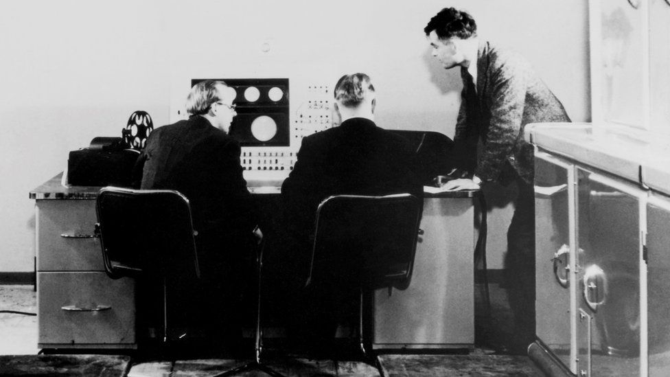 Alan Turing (right) and colleagues working on the Ferranti Mark I Computer, 1951