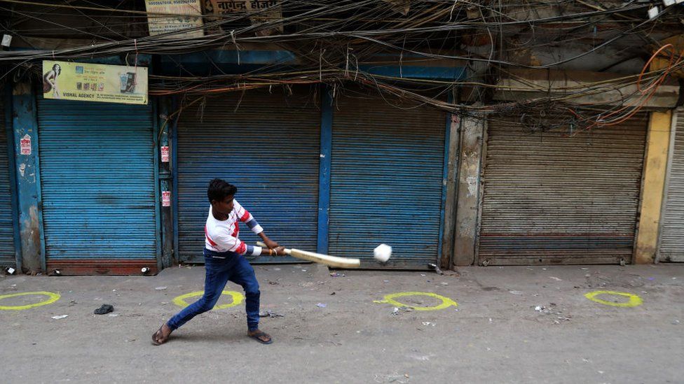 A boy playing cricket in the closed market at Sadar Bazar wholesale market during the weekend lockdown imposed by the State government to curb again spike of coronavirus (Covid-19) cases