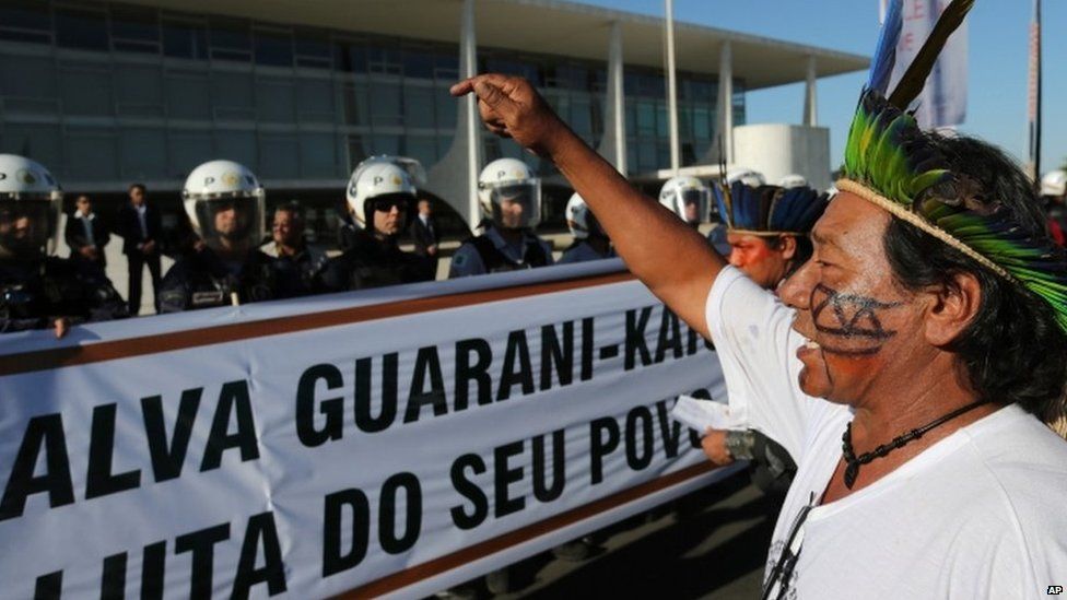 a Guarani Kaiowa Indian leader denounces the murder of indigenous leader Simao Vilhalva during a protest in front of the Planalto Presidential Palace, in Brasilia, Brazil, Tuesday, Sep. 1, 2015.