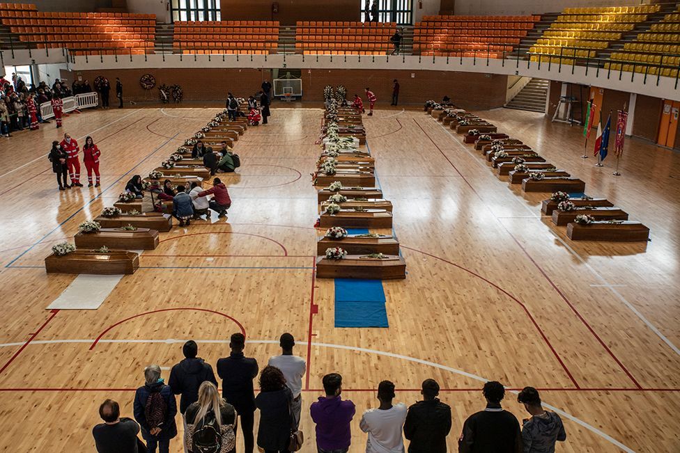 Coffins lined up in a gymnasium in Crotone, Italy