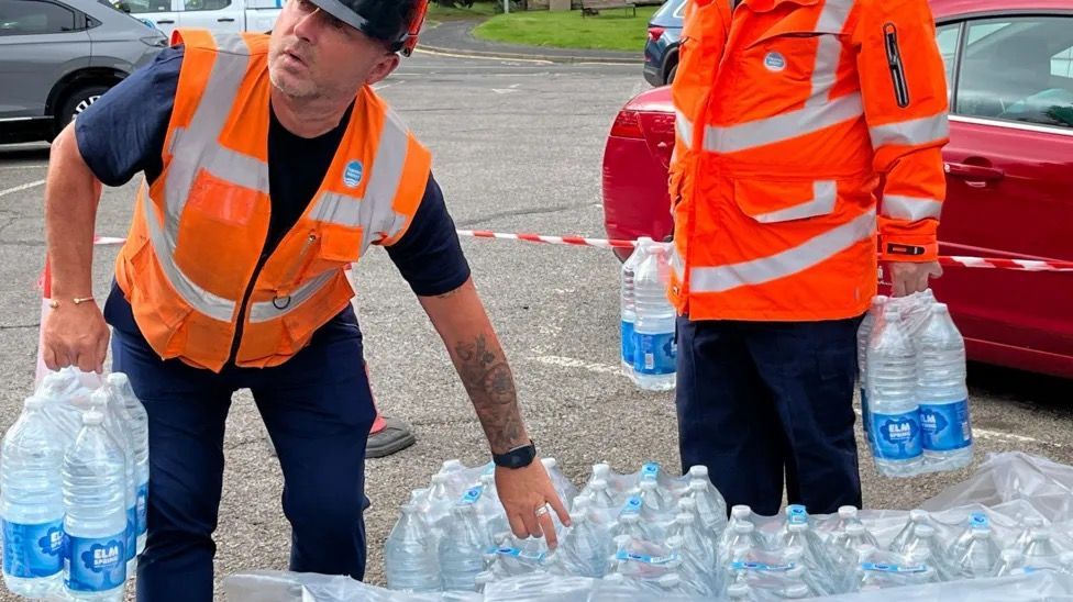 Volunteers helping give out water 