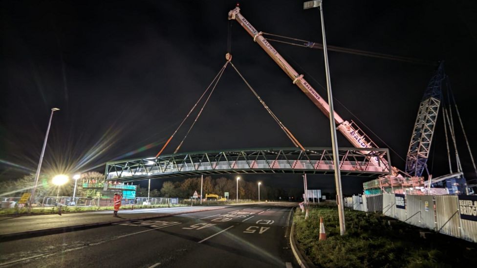 Oswestry A5 footbridge lifted into position - BBC News