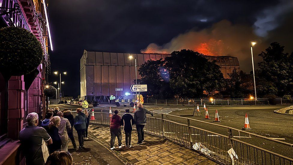 People watch the former Ayr Station Hotel on fire