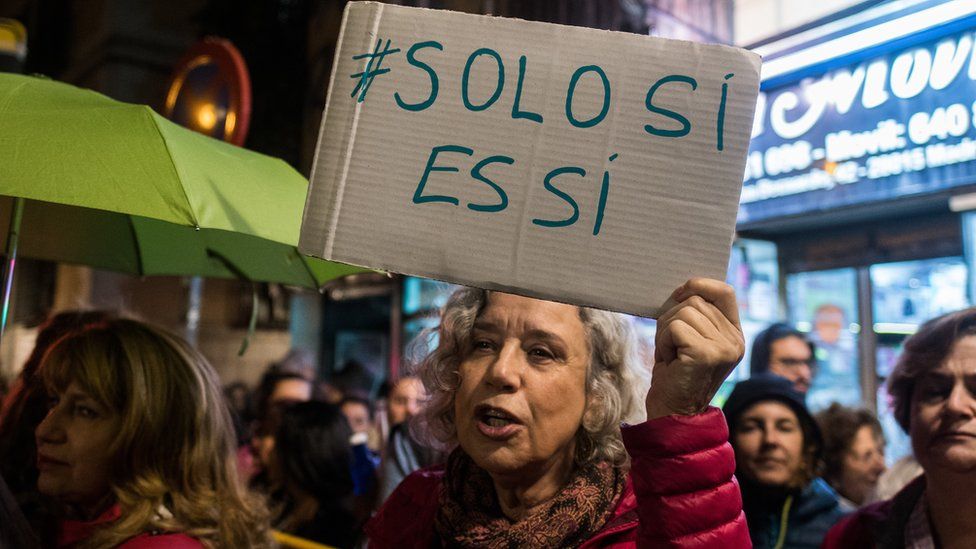 A woman with a placard that reads 'only yes is yes' protesting against the gang of men known as 'The Manresa wolf pack