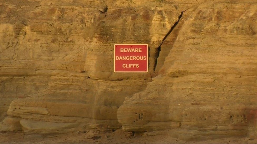Warning sign on cliffs
