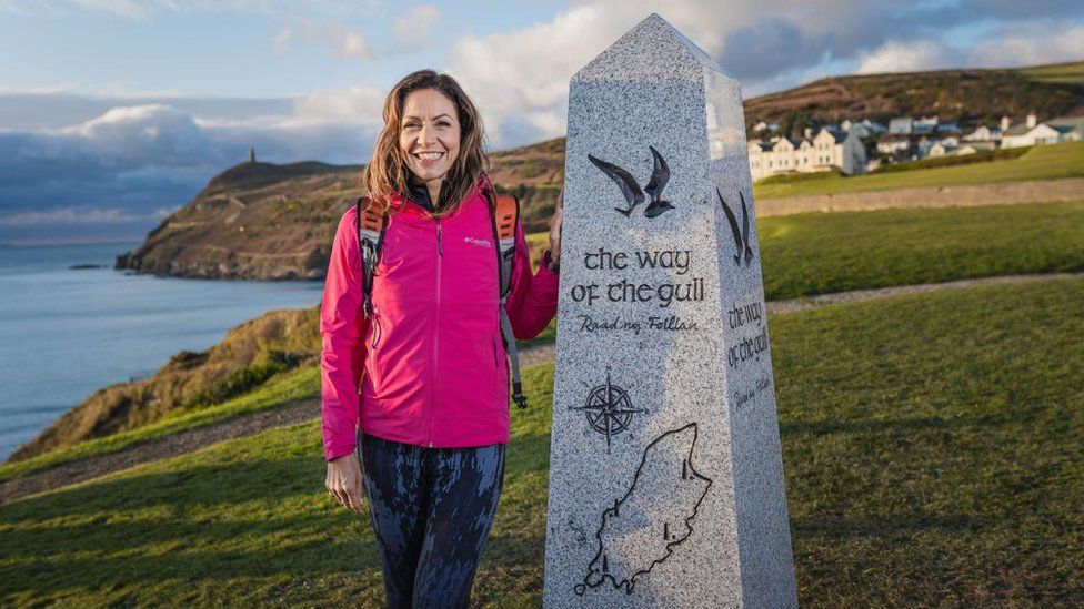 Julia Bradbury next to a granite marker