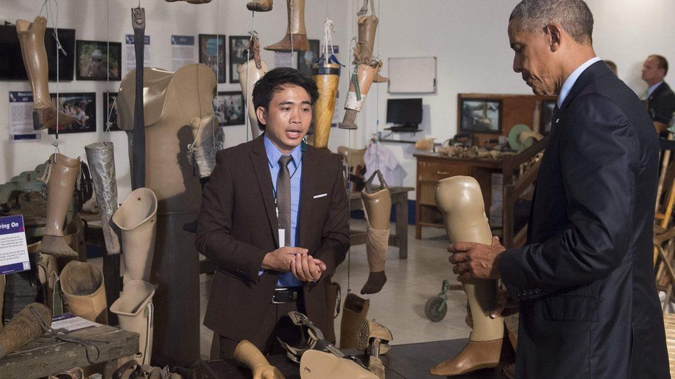 US President Barack Obama holds a prosthetic limb as he tours the Cooperative Orthotic and Prothetic Enterprise (COPE) visitor center in Vientiane on September 7, 2016