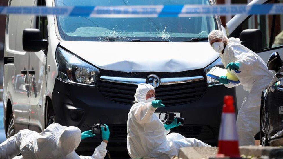 Forensic investigators examining a damaged van in Nottingham