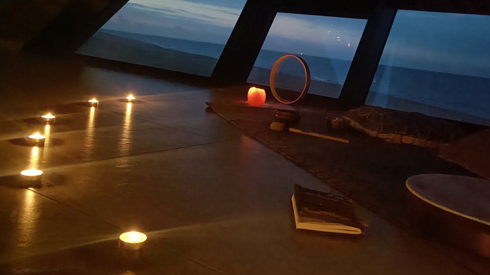 Candles lit in a yoga room