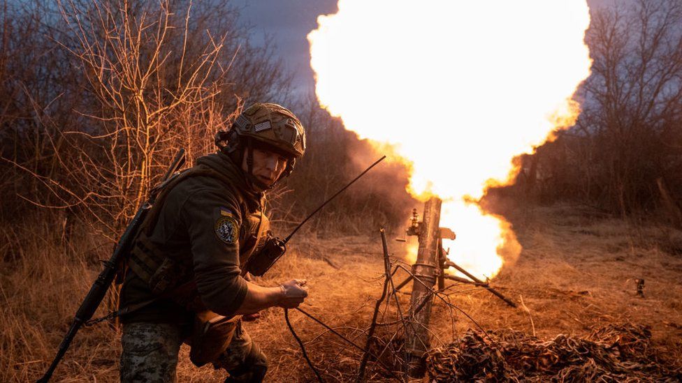 Ukrainian soldier fires a mortar
