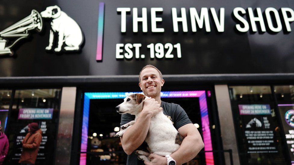 HMV owner Doug Putman with Ollie the dog outside the Oxford Street store