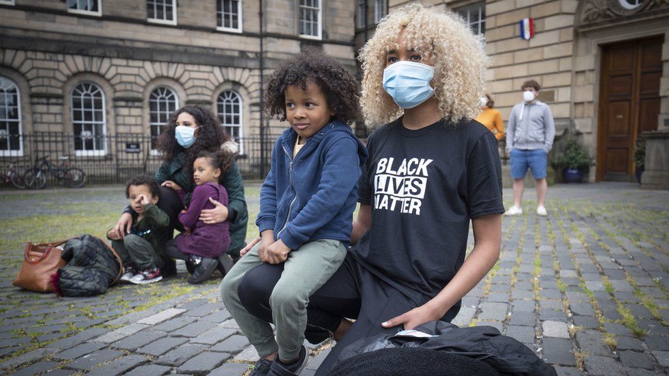 Demonstrators take part in the Take A Knee for George Floyd solidarity protest organised by Stand Up To Racism Scotland, outside St Giles" Cathedral in Edinburgh in memory of George Floyd who was killed on May 25 while in police custody in the US city of Minneapolis.