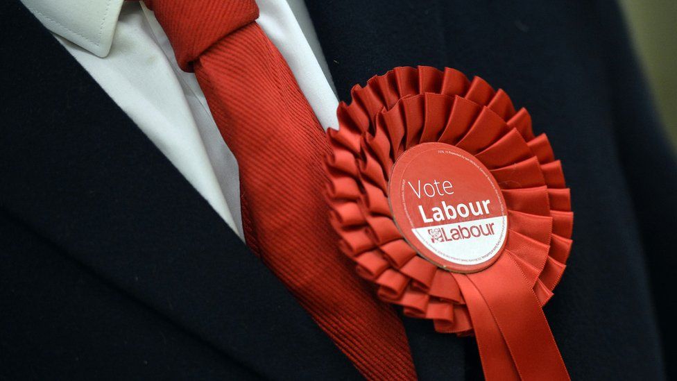 Labour supporter wearing a party rosette