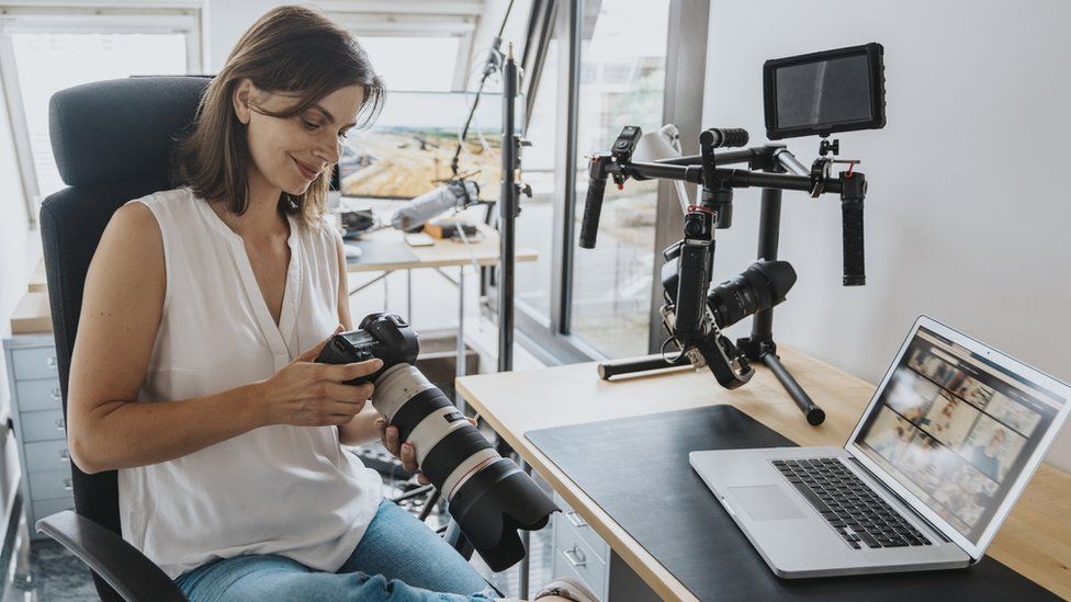 A stock image of a professional photographer reviewing pictures