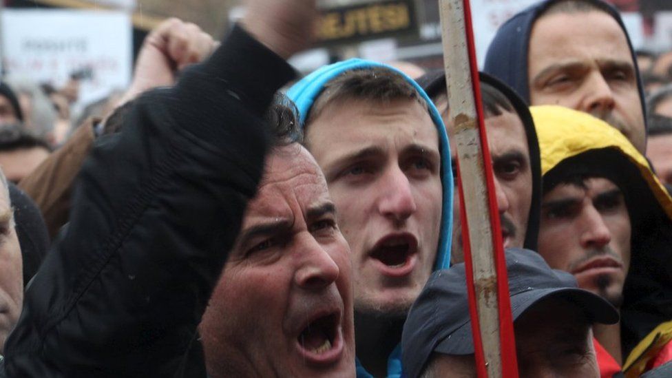 A man waves his fist during the protest