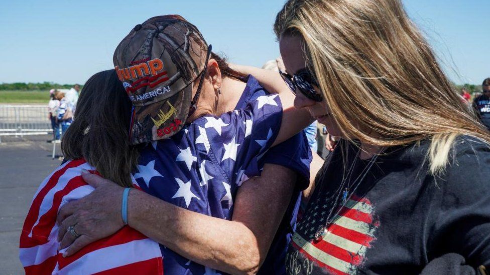 Trump supporters hug at the rally