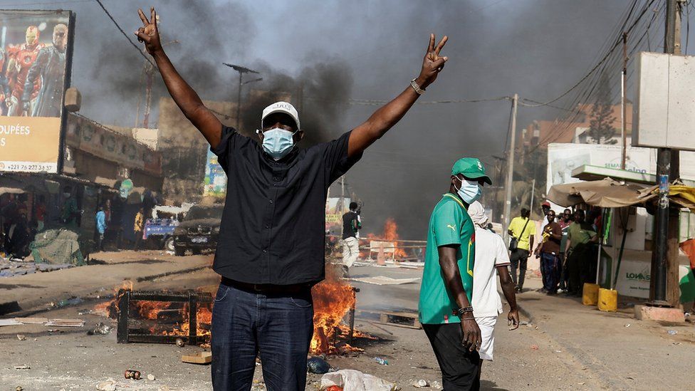 A Senegalese demonstrator reacts during clashes with riot police as they protest against the postponement of the Feb. 25 presidential election, in Dakar, Senegal February 4, 2024.