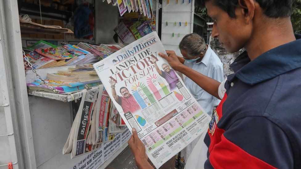 A person looks at a newspaper with parliamentary elections coverage, in Colombo, Sri Lanka, 07 August 2020.
