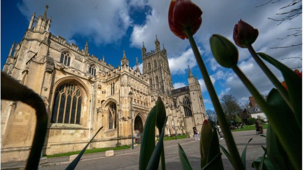 Exterior shot of Gloucester Cathedral, captured through some tulips