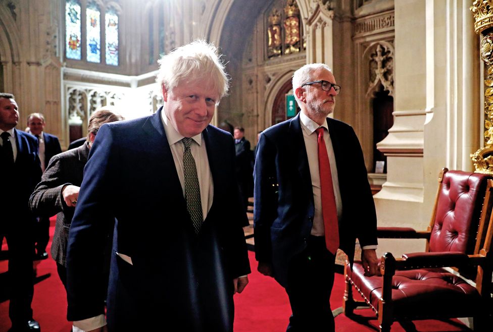Prime Minister Boris Johnson (left) and Labour Party leader Jeremy Corbyn walk through the Peers Lobby