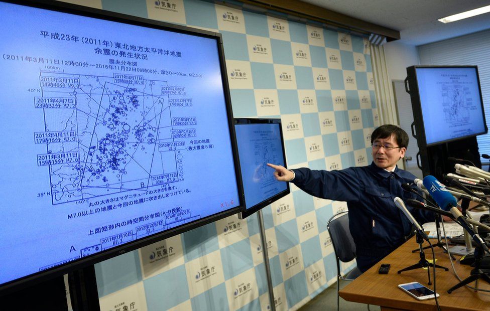 Japan Meteorological Agency (JMA) earthquake observation division Koji Nakamura points to screens during a press conference, after a strong earthquake hit off the coast of Fukushima Prefecture, at the JMA headquarters in Tokyo, Japan, 22 November 2016.