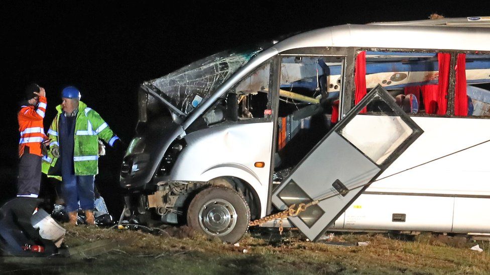 The crashed minibus in a field in the Scottish borders